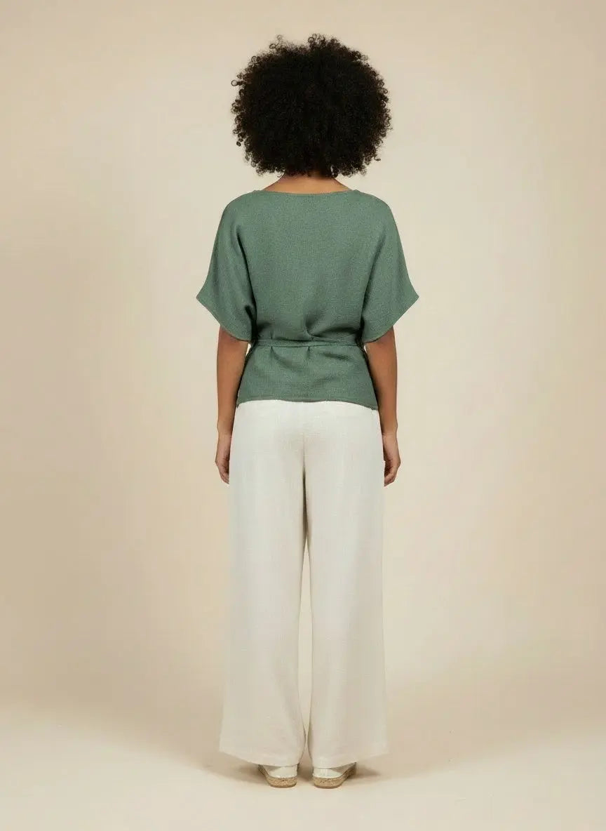 Back pose of the model wearing Beaded Neckline Short Sleeve Blouse