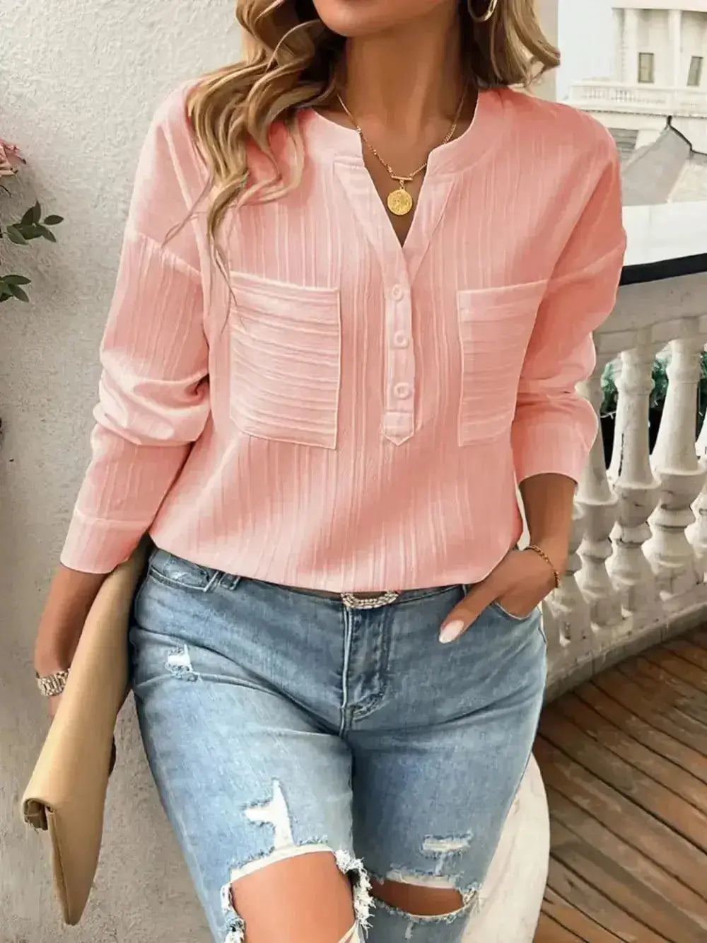 Pink long sleeve blouse with front pockets, paired with ripped jeans, perfect for casual spring outfits.