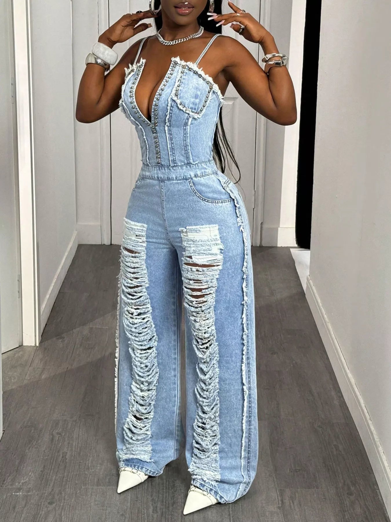 Distressed Spaghetti Strap Wide-Leg Denim Jumpsuit – Close-Up Studded V-Neckline and Corset Bodice Detail