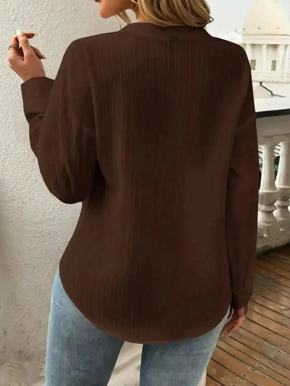 Brown ribbed long-sleeve top paired with blue jeans, modern minimalist women's fashion