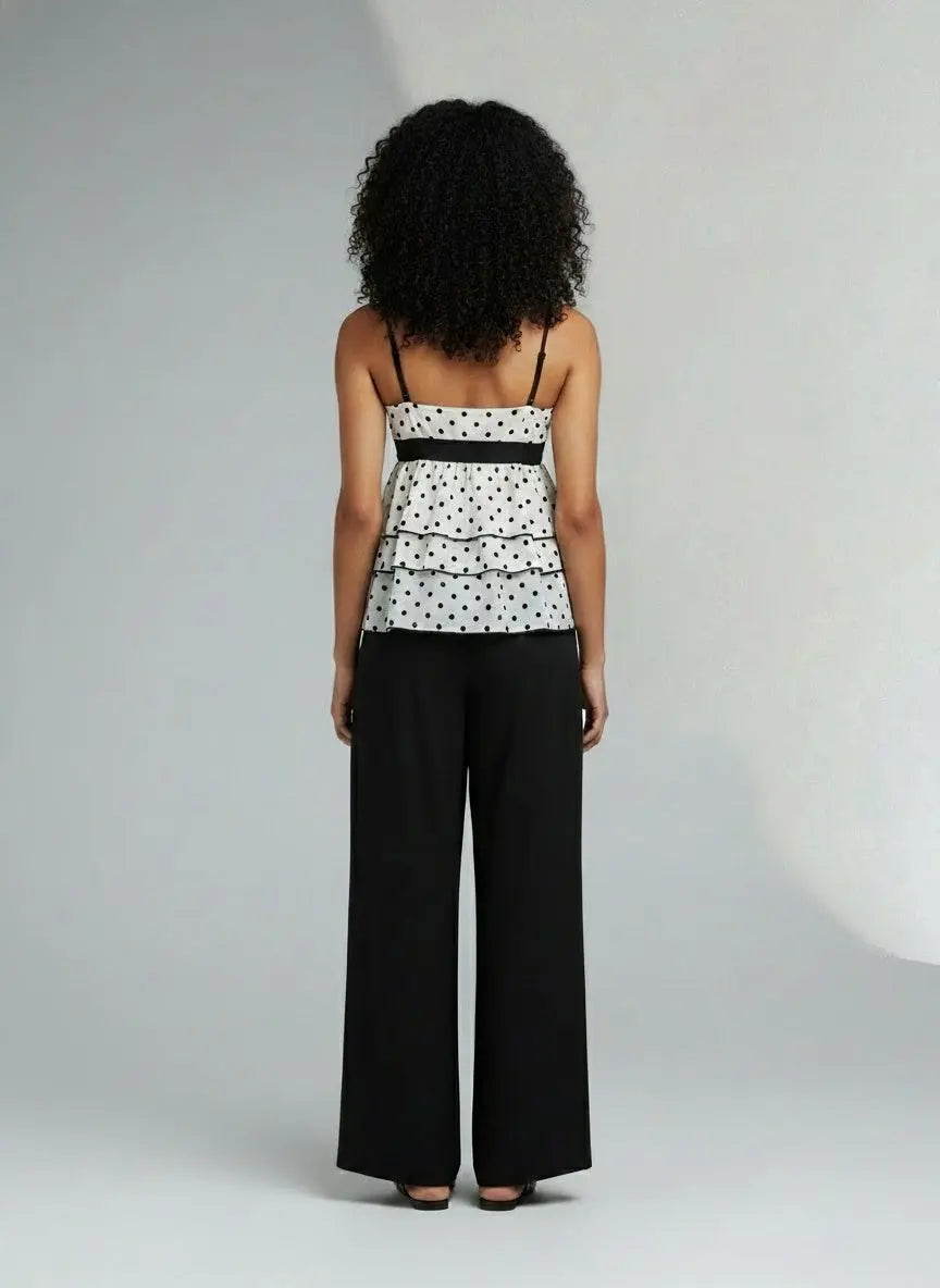 Back pose of the model wearing Polka Dot Ruffle Hem Cami with Lace Trim
