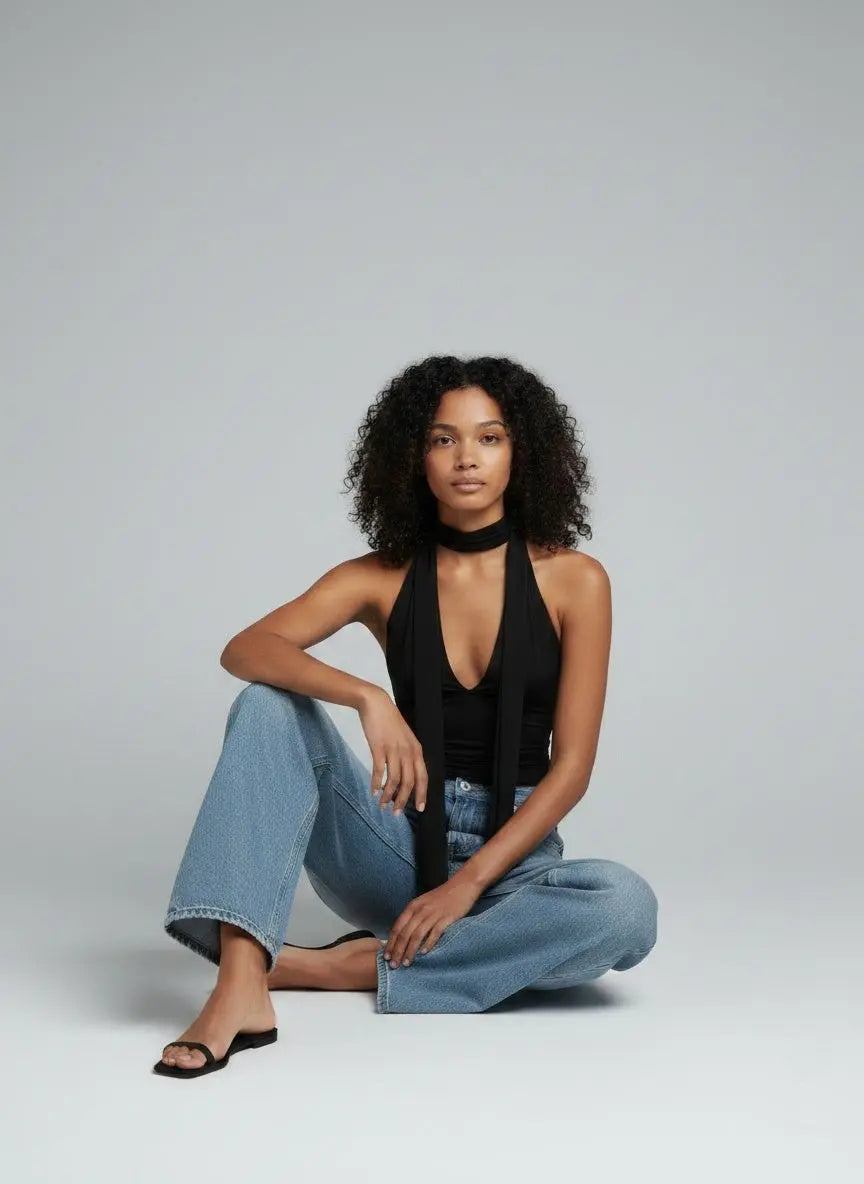 Model sitting while wearing Halter Neck Tie Cami