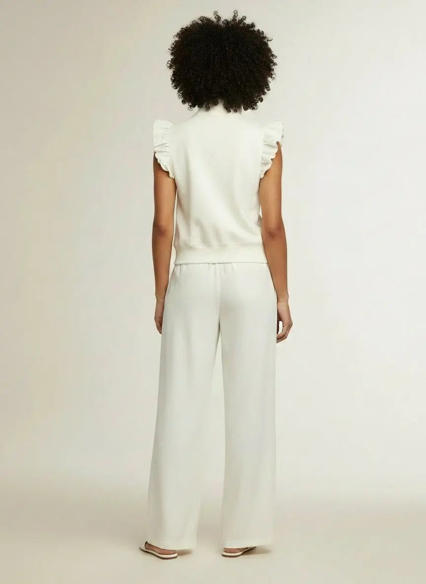 Back pose of the model wearing Zipped up Collared Ruffled Short Sleeve Blouse