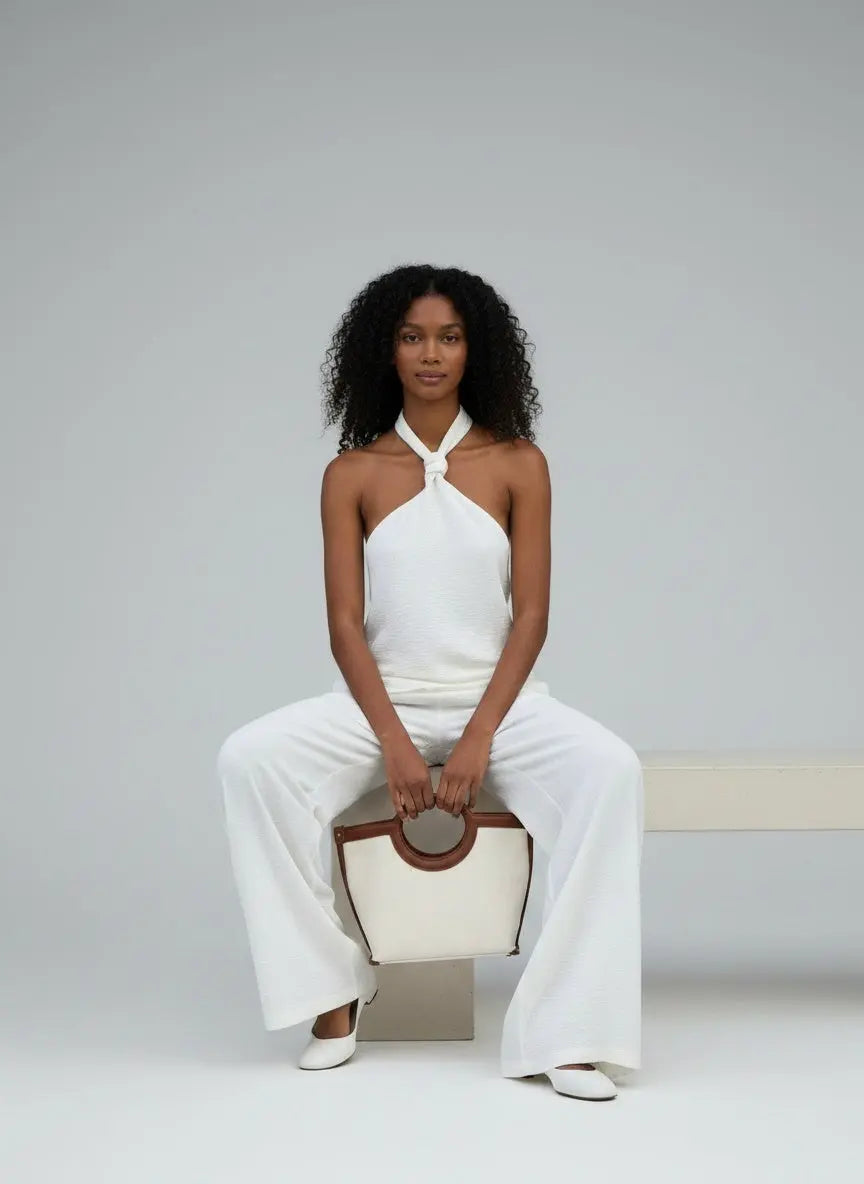 Model sitting while wearing Knotted Halter Neck Cami