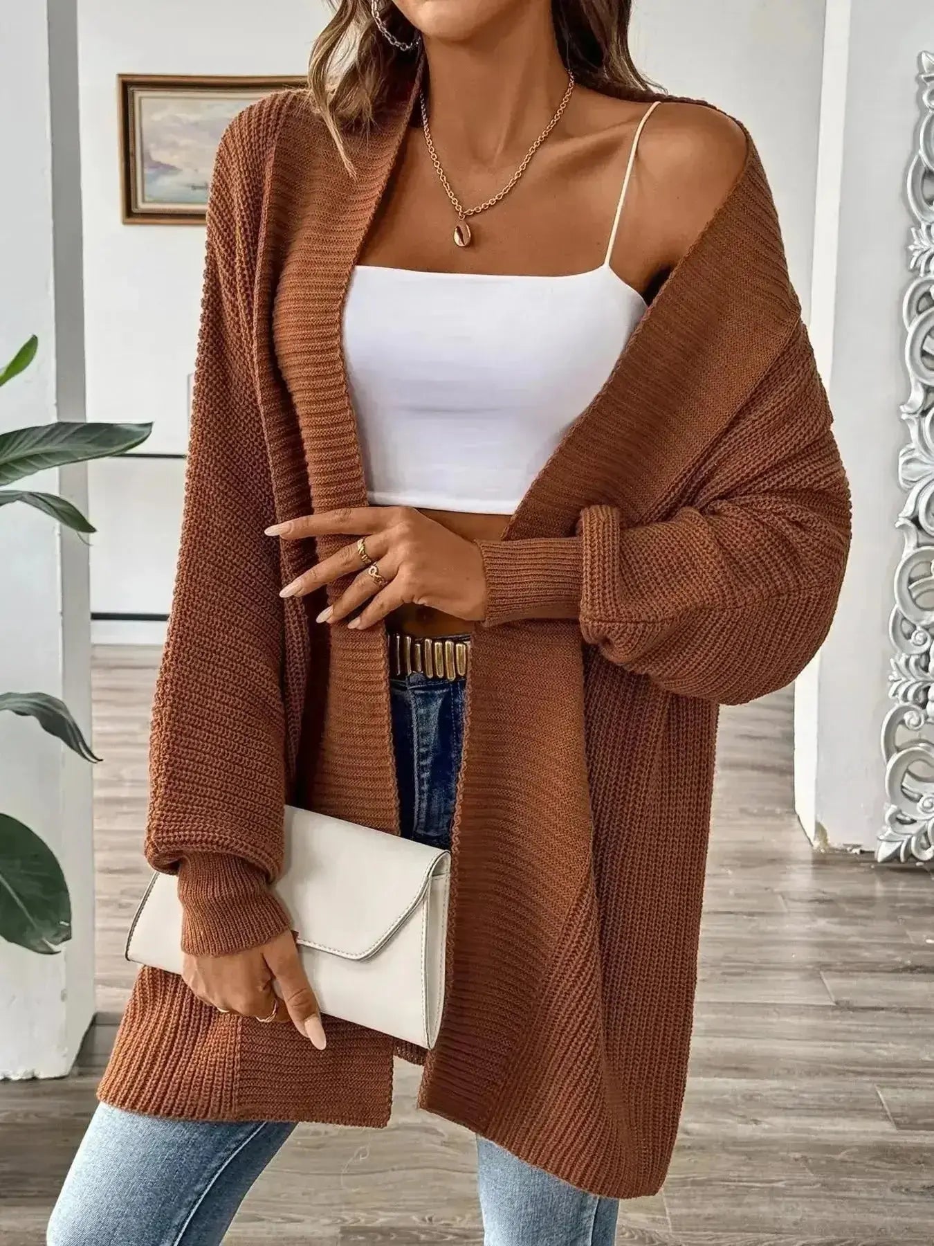 Brown ribbed knit cardigan over white cami with jeans, styled for modern minimalist women's fashion