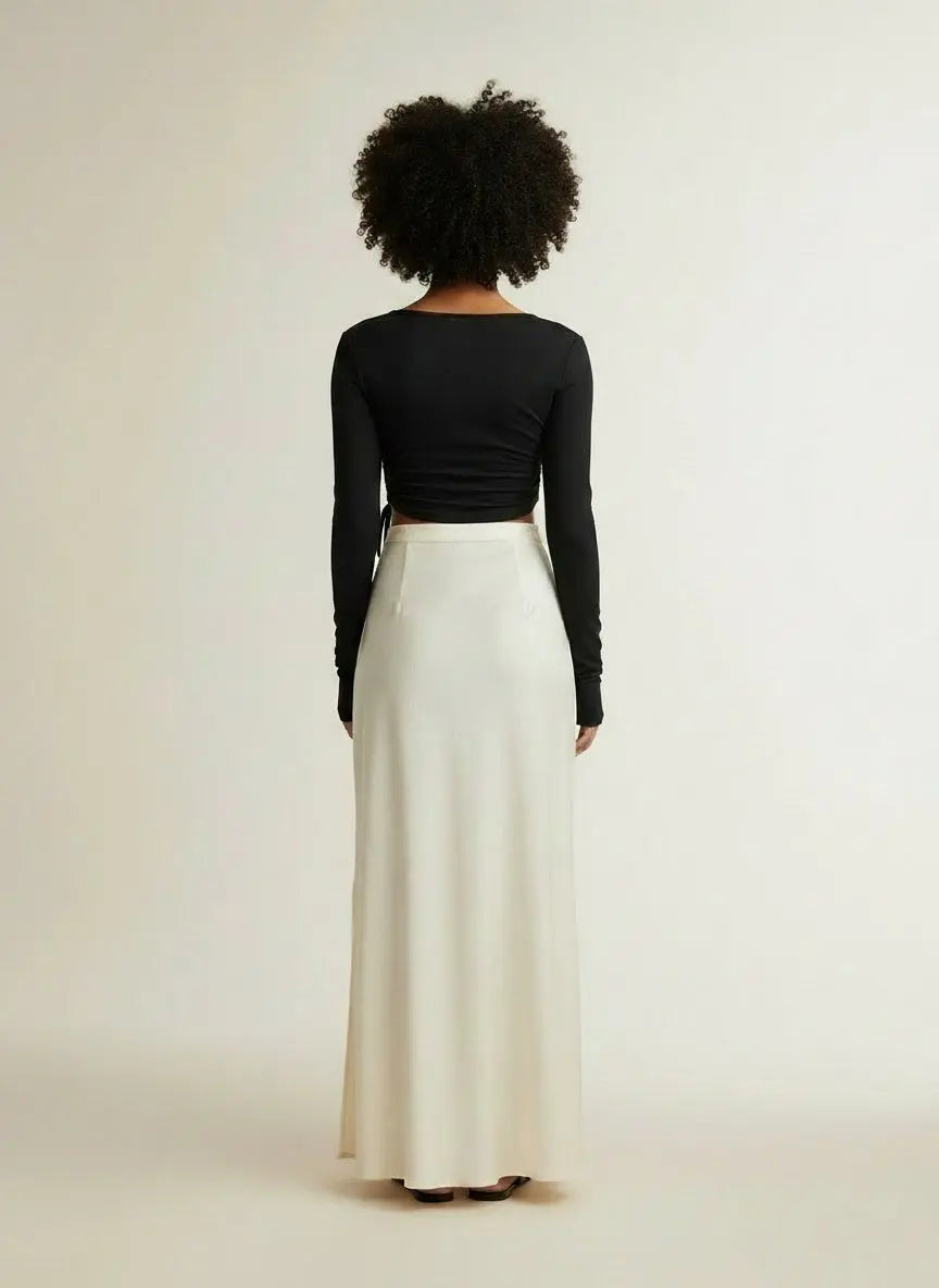 Back pose of the model wearing Ivy Lane Asymmetrical Long Sleeve Side Tie Blouse