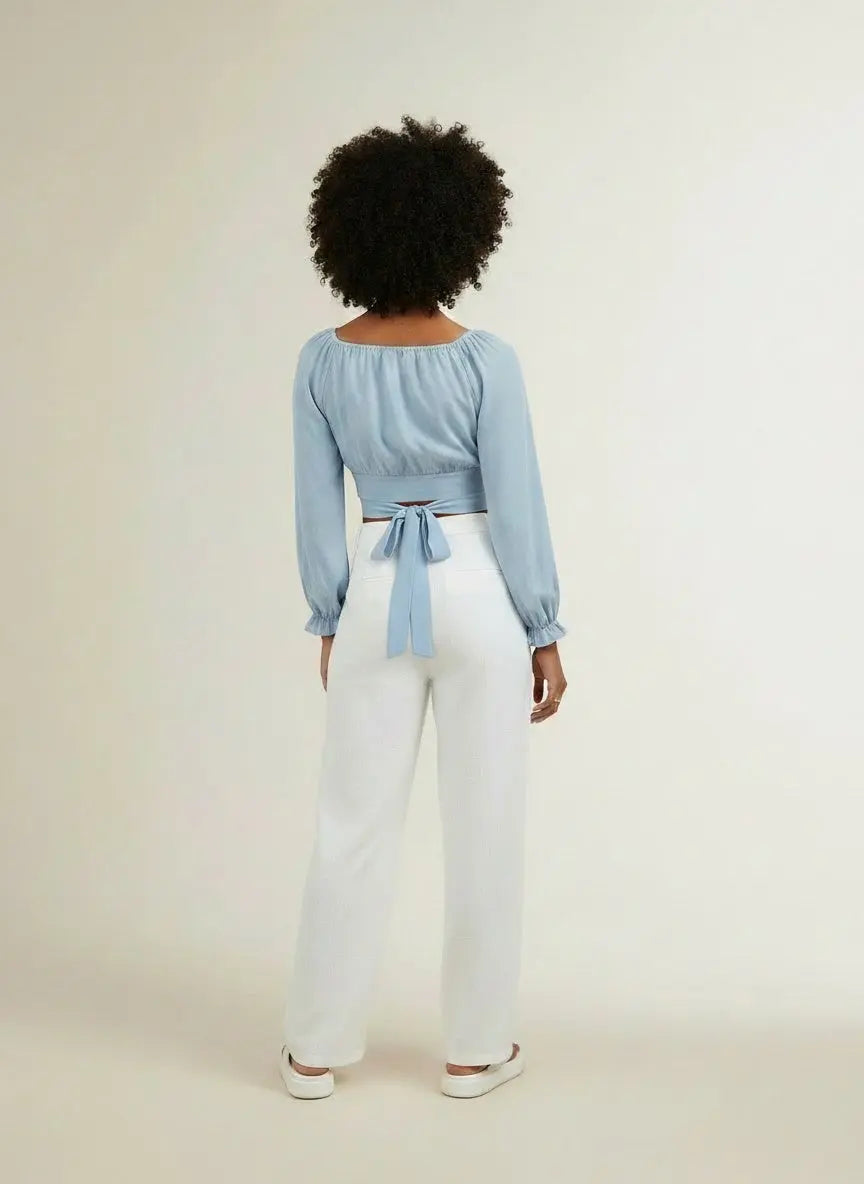 Back pose of the model wearing Honey Raglan Sleeve Cropped Blouse