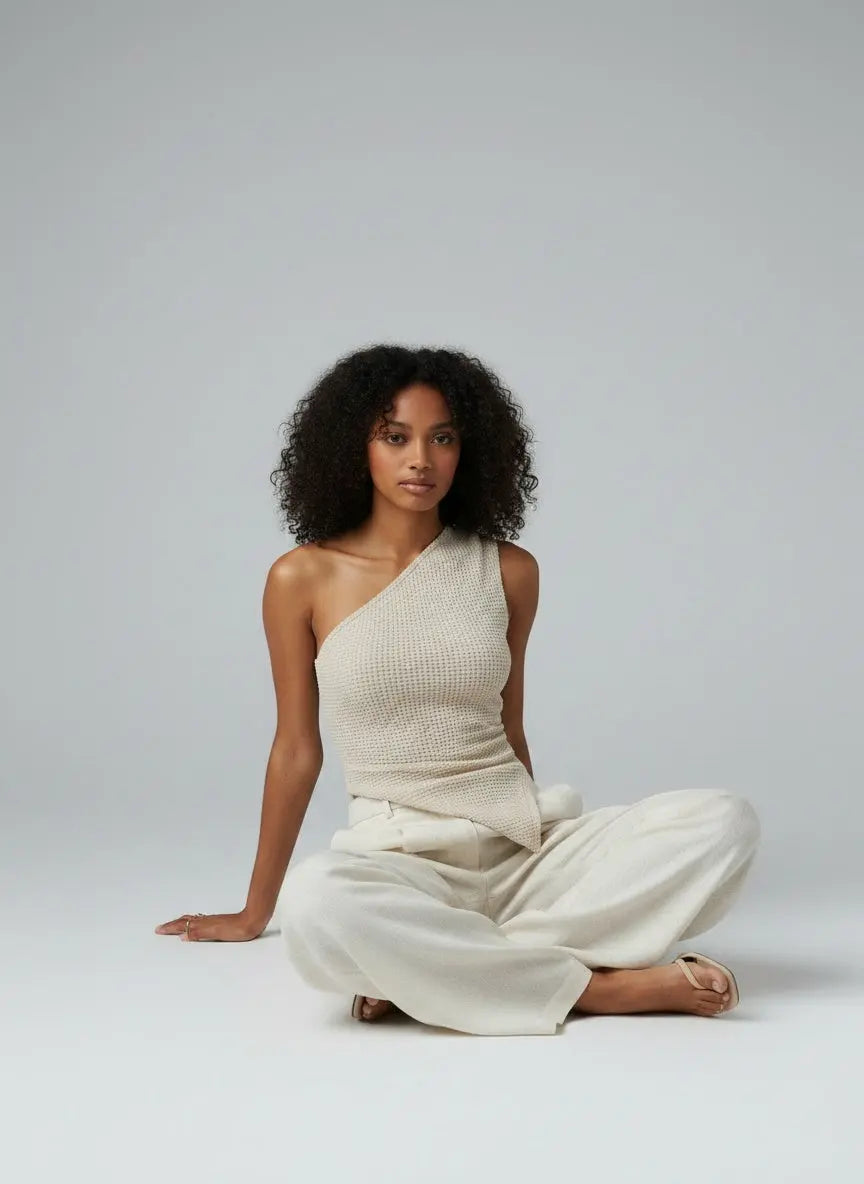 Model sitting while wearing Textured Waffle Knit One-Shoulder Tank