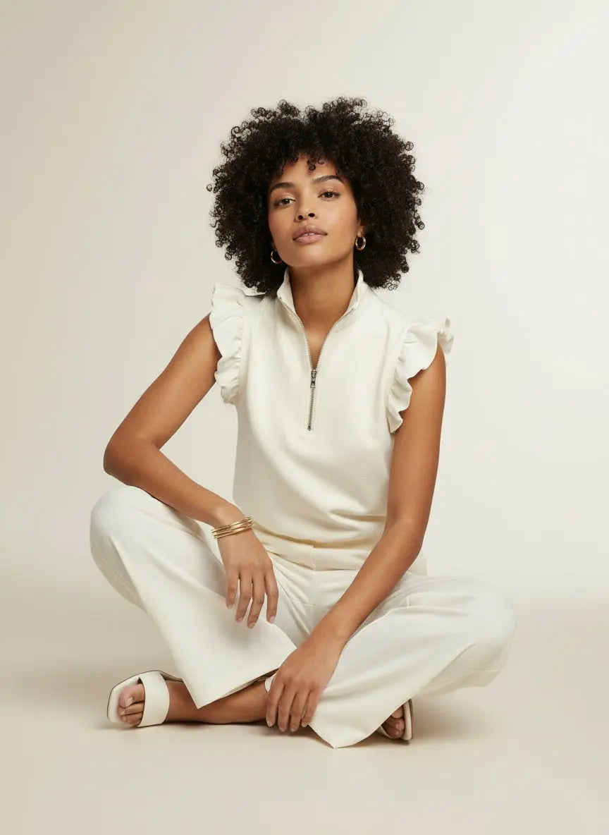 Model sitting while wearing Zipped up Collared Ruffled Short Sleeve Blouse