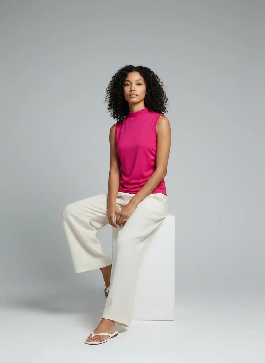 Model sitting while wearing Ruched Mock Neck Tank