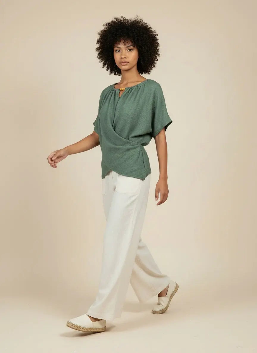 Model walking while wearing Beaded Neckline Short Sleeve Blouse